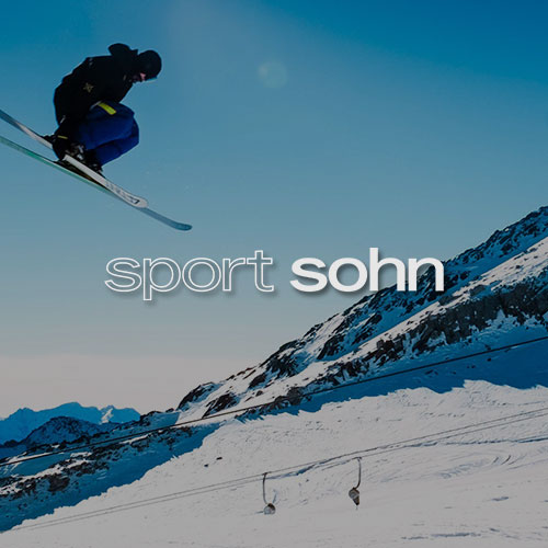 Skifahrer in den Bergen. Mittig im Bild wird das Sport Sohn Logo dargestellt.